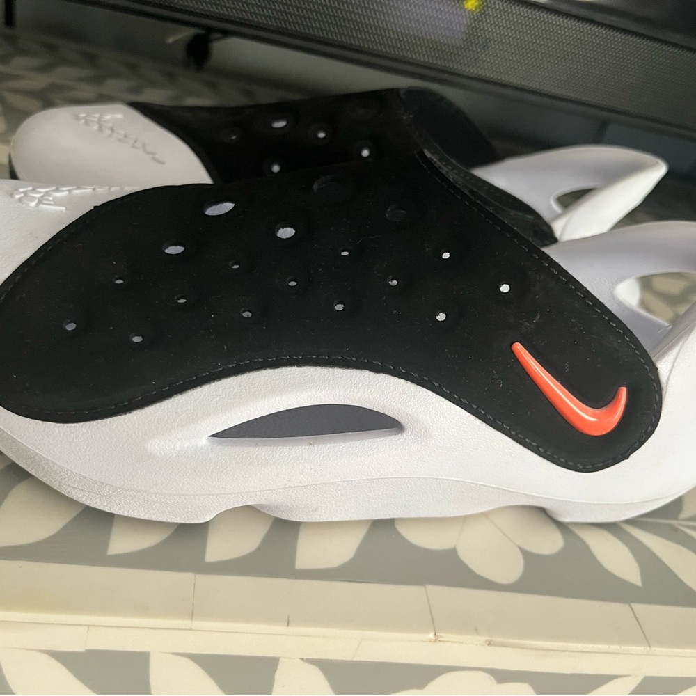 Nike Kids Black and White Slide Sandals with Orange Swoosh Accent